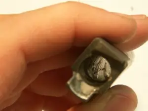 A barrel muzzle with grey lead build-up lining the bore
